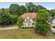 Charming two-story home featuring a well-manicured front yard and a classic design with beautiful landscaping at 600 Oakmont Hl, Duluth, GA 30097