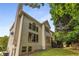 Multi-story home showcasing large windows and an attached deck, set within a lush green landscape at 600 Oakmont Hl, Duluth, GA 30097