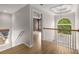 Upstairs hallway with hardwood floors, detailed ceiling, and view into a bedroom at 600 Oakmont Hl, Duluth, GA 30097