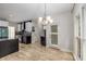 Bright kitchen features wood floors, granite counters, stainless appliances, and a modern chandelier at 600 Oakmont Hl, Duluth, GA 30097