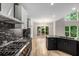 Bright kitchen with wood floors, granite counters, stainless appliances, and large windows at 600 Oakmont Hl, Duluth, GA 30097