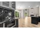 Open concept great room with black granite counters and cabinets, hardwood floors and large windows at 600 Oakmont Hl, Duluth, GA 30097