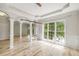 Open living area showcasing hardwood floors, large windows, recessed lighting, and elegant crown molding detail at 600 Oakmont Hl, Duluth, GA 30097