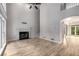 Large living room featuring a cozy fireplace, white trim and large windows at 600 Oakmont Hl, Duluth, GA 30097