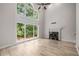 Grand living room with vaulted ceilings, a cozy fireplace, and large windows providing plenty of natural light at 600 Oakmont Hl, Duluth, GA 30097