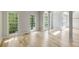 Bright living room featuring light hardwood floors, white trim, and large windows at 600 Oakmont Hl, Duluth, GA 30097