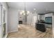 Spacious living room features wood floors, fireplace, large windows, and an open concept to the kitchen at 600 Oakmont Hl, Duluth, GA 30097