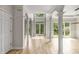 Bright living room featuring beautiful light hardwood floors, white trim, and large windows with wooded view at 600 Oakmont Hl, Duluth, GA 30097