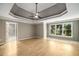 Spacious main bedroom with hardwood floors, tray ceiling, and windows overlooking the yard at 600 Oakmont Hl, Duluth, GA 30097