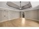 Spacious main bedroom featuring hardwood floors, tray ceiling, and closet door at 600 Oakmont Hl, Duluth, GA 30097