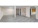 Finished basement with gray vinyl floors and shelving units at 739 Dushea Nw Ct, Kennesaw, GA 30144