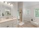Bright bathroom features a walk-in shower, tub, and double vanity at 739 Dushea Nw Ct, Kennesaw, GA 30144