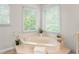 Inviting soaking tub with window views at 739 Dushea Nw Ct, Kennesaw, GA 30144