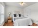 Bright bedroom features a ceiling fan, wood floors, and a stylishly decorated bed at 739 Dushea Nw Ct, Kennesaw, GA 30144