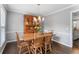 Traditional dining room with wood table, chairs, hutch, chandelier and warm hardwood flooring at 739 Dushea Nw Ct, Kennesaw, GA 30144