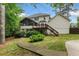 Backyard features a deck, screened in porch, mature trees, and landscaping at 739 Dushea Nw Ct, Kennesaw, GA 30144