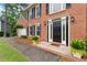 Inviting front entrance with brick walkway, potted plants, and a classic black door at 739 Dushea Nw Ct, Kennesaw, GA 30144