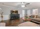 Living room with dark wood floors, a TV and a comfortable couch and coffee table at 739 Dushea Nw Ct, Kennesaw, GA 30144