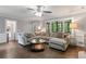 Spacious living room with hardwood floors, large windows, and an ample sectional sofa at 739 Dushea Nw Ct, Kennesaw, GA 30144