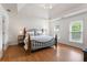 Spacious main bedroom features tray ceiling, hardwood floors, and natural light from two large windows at 739 Dushea Nw Ct, Kennesaw, GA 30144