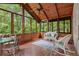 Relaxing sunroom features a wood ceiling and views of the surrounding trees and greenery at 739 Dushea Nw Ct, Kennesaw, GA 30144