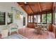 Enclosed sunroom with ceiling fan, wood floors and ceilings, and white wicker furniture at 739 Dushea Nw Ct, Kennesaw, GA 30144
