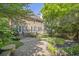 Large backyard featuring a deck, stone patio, lush landscaping, and a privacy fence at 1064 Saint James Xing, Brookhaven, GA 30319