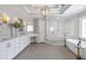 Bathroom features white vanities, a glass-enclosed shower, and a soaking tub at 1064 Saint James Xing, Brookhaven, GA 30319