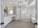Bathroom with white vanities, soaking tub, glass-enclosed shower, and modern fixtures at 1064 Saint James Xing, Brookhaven, GA 30319
