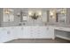 Bright bathroom with double sinks, marble countertops, white cabinets, and stylish light fixtures at 1064 Saint James Xing, Brookhaven, GA 30319