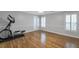 This bedroom features beautiful hardwood flooring, neutral paint, and plantation shutters at 1064 Saint James Xing, Brookhaven, GA 30319