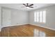 This bedroom features beautiful hardwood flooring, neutral paint, and plantation shutters at 1064 Saint James Xing, Brookhaven, GA 30319