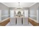 Elegant dining room with modern chandelier, neutral walls, and ample seating at 1064 Saint James Xing, Brookhaven, GA 30319