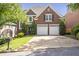 Charming brick home with a well-manicured lawn, a two-car garage, and lush landscaping at 1064 Saint James Xing, Brookhaven, GA 30319