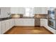 Bright kitchen featuring stainless appliances, modern cabinetry, and hardwood floors for a functional space at 1064 Saint James Xing, Brookhaven, GA 30319