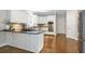 Kitchen with island, stainless appliances, tile backsplash, and hardwood floors for a chef's delight at 1064 Saint James Xing, Brookhaven, GA 30319