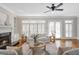 Cozy living room with fireplace, hardwood floors, and plenty of natural light at 1064 Saint James Xing, Brookhaven, GA 30319