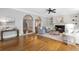 Spacious living room featuring hardwood floors, fireplace, built-ins, and elegant archways at 1064 Saint James Xing, Brookhaven, GA 30319