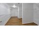 Spacious walk-in closet featuring hardwood floors and built-in shelving at 1064 Saint James Xing, Brookhaven, GA 30319