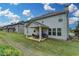 Backyard view featuring a covered patio, well-maintained lawn, and siding details at 1200 Bar Harbor Pl, Lawrenceville, GA 30044