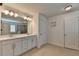 Spacious bathroom with double vanity, sleek cabinets, and a view into the glass shower and tub at 1200 Bar Harbor Pl, Lawrenceville, GA 30044