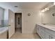Well-lit bathroom showcasing a double vanity, with access to a soaking tub and walk-in shower at 1200 Bar Harbor Pl, Lawrenceville, GA 30044