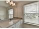 Bathroom featuring a modern vanity with a large mirror and a window with natural light at 1200 Bar Harbor Pl, Lawrenceville, GA 30044