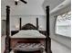 Elegantly styled bedroom featuring a four-poster bed and a cushioned bench for a luxurious feel at 1200 Bar Harbor Pl, Lawrenceville, GA 30044