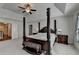 Bright bedroom with a four-poster bed, complemented by side tables and a plush upholstered bench at 1200 Bar Harbor Pl, Lawrenceville, GA 30044