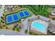 Aerial view showcasing the community pool, tennis courts, and playground in a landscaped setting at 1200 Bar Harbor Pl, Lawrenceville, GA 30044