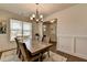 Inviting dining room area with large windows, wainscoting, and an elegant chandelier at 1200 Bar Harbor Pl, Lawrenceville, GA 30044