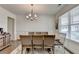 Formal dining room featuring wainscoting, hardwood floors, stylish chandelier, and a neutral color palette at 1200 Bar Harbor Pl, Lawrenceville, GA 30044