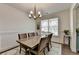 Bright dining room boasts natural light, wainscoting, neutral decor, and space for gatherings at 1200 Bar Harbor Pl, Lawrenceville, GA 30044