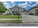 Charming two-story home featuring stone accents, a three-car garage, and beautifully landscaped front yard at 1200 Bar Harbor Pl, Lawrenceville, GA 30044